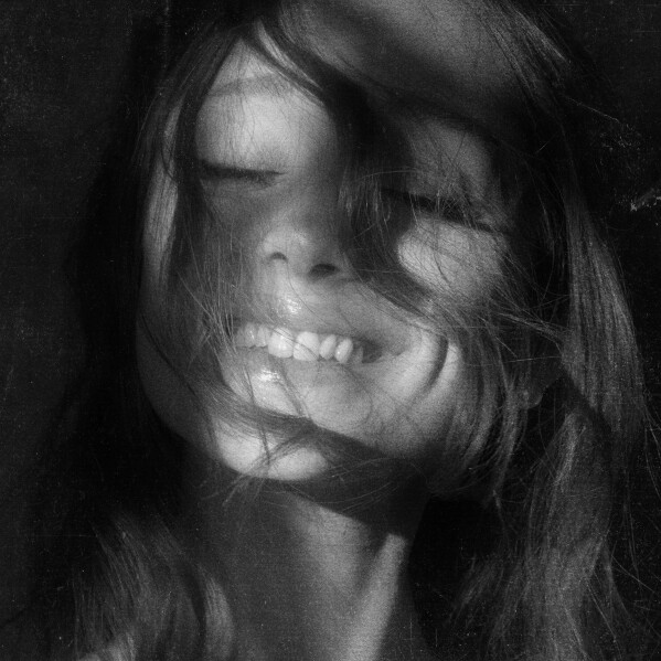 Ariana Grande petal official album cover — black and white portrait with hair across face